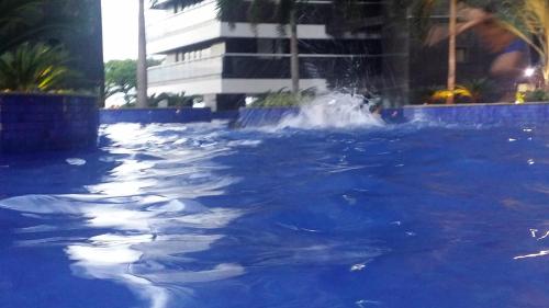 a pool with a fountain in the middle of a building at Landscape Apartment TC1502 in Fortaleza
