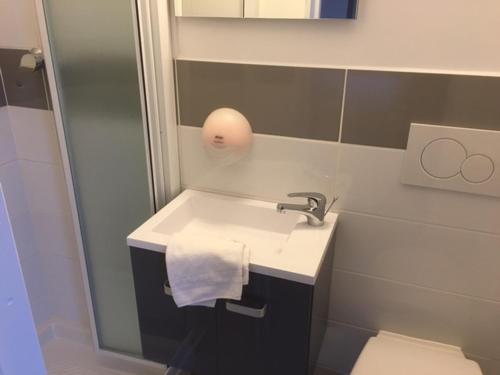 a bathroom with a sink and a toilet at Le Relais de Monti in Menton