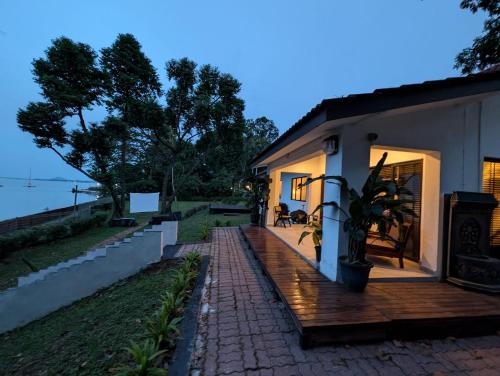 a house with a wooden deck next to a building at House of Melissa Boutique Farmstay in Singapore