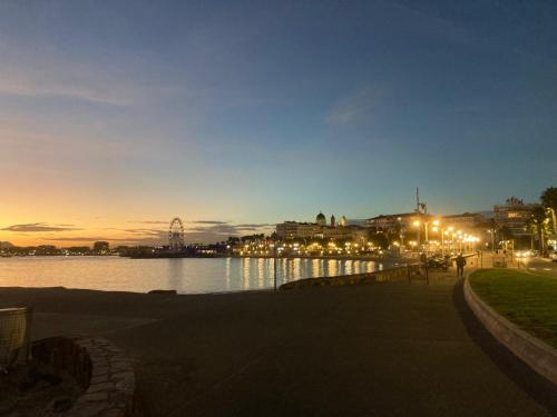 a view of a body of water at night at Balcon, parking, piscine et clim' à 2 pas du port Santa Lucia in Saint-Raphaël