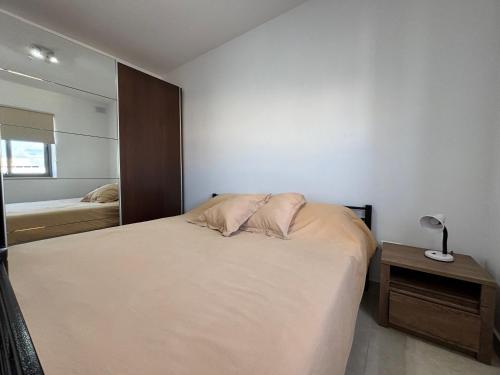 a bedroom with a bed and a mirror at Home vibes in L-Armier