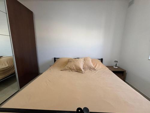 a bed in a bedroom with a large mirror at Home vibes in L-Armier