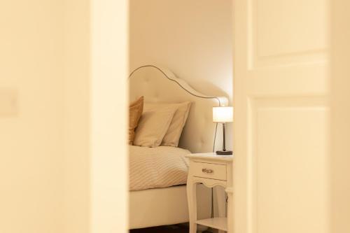 a bedroom with a bed and a table with a lamp at Dimora Margherita in Caserta