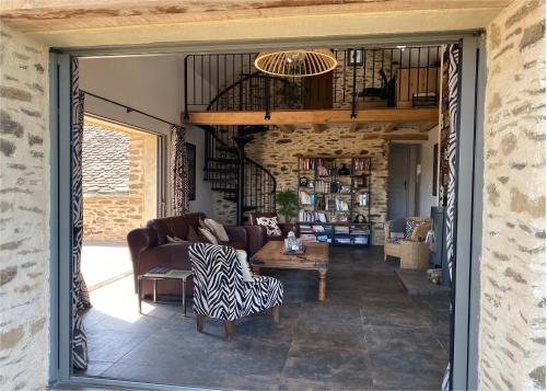 a living room with a couch and a table at Olisios, beautiful farmhouse with private pool in Pampelonne