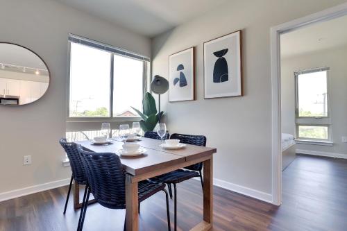 a dining room with a table and chairs and windows at Spacious Apt w All Amenities That You Need! in Alexandria