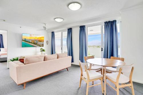 a living room with a couch and a table at Cairns Central Condo in Cairns