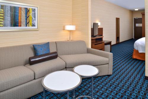 a living room with a couch and two tables at Fairfield Inn & Suites by Marriott Sacramento Airport Woodland in Woodland