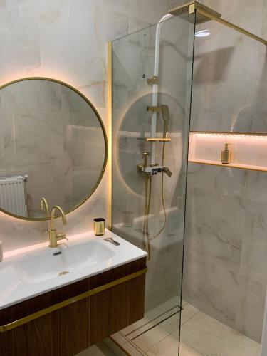 a bathroom with a sink and a shower with a mirror at Kastoria NYC in Kastoria