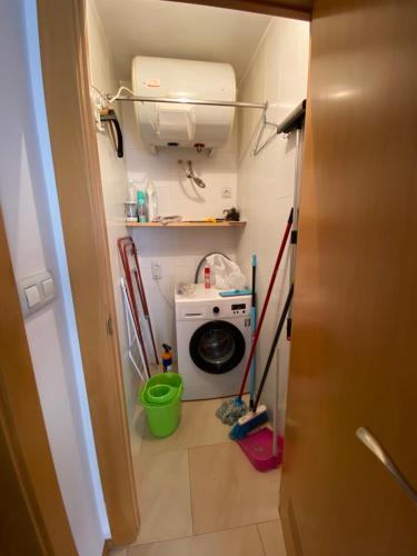 a laundry room with a washing machine and a washer at Estación 1 in Murcia
