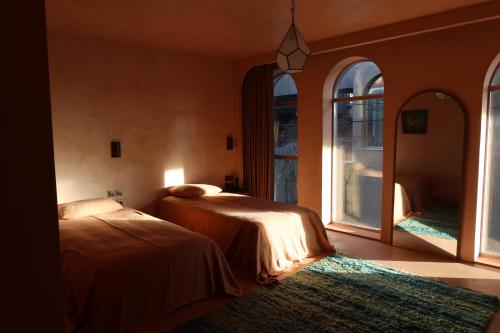 a bedroom with two beds and a large window at Life Gallery Hotel & Spa in Korçë