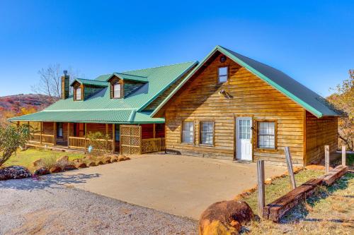 a wooden house with a green roof at Spacious Cabin with Views, Near Lake Lawtonka! in Medicine Park