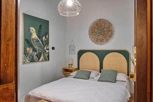 a bedroom with a bed and a picture of a bird at Corte Cenci House in Tivoli