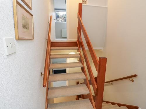 a staircase in a house with wooden railings at High Tide in Cowes
