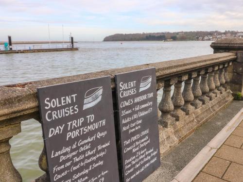 a sign for a day trip to a pier at High Tide in Cowes