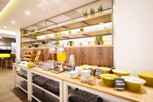 a kitchen with a counter with food on it at Holiday Inn London - Gatwick Airport by IHG in Horley