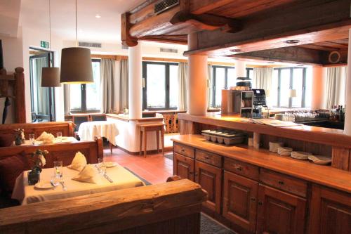 a large kitchen with wooden cabinets and a table at Hotel Erzgiesserei Europe in Munich