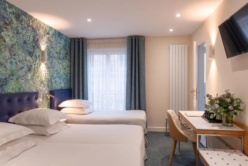 a hotel room with two beds and a desk at Hôtel Albe Saint Michel in Paris