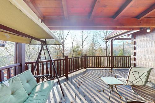 a screened in porch with a couch and a chair at Mama Bear's Dream in Sevierville