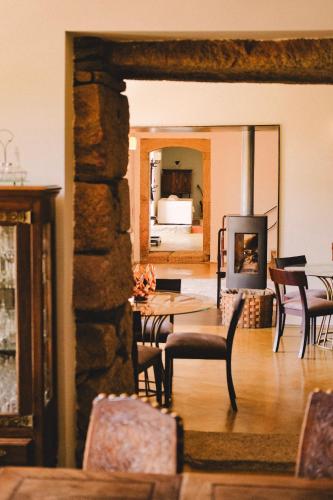 a living room with a fireplace and a table and chairs at Casal de Tralhariz - Douro Valley in Tralhariz