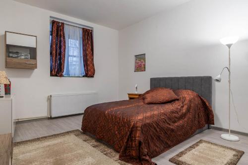 a bedroom with a bed and a lamp at Varkert Green 16 in Budapest