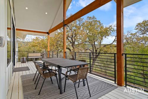 a patio with a table and chairs on a balcony at Modern 3BR 3BA in Steiner Ranch w Balcony Dining Yard w Grill by Austin Vacay in Austin