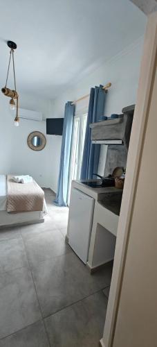 a kitchen with a sink and a bed in a room at Joannes Vacation Rooms in Adamas