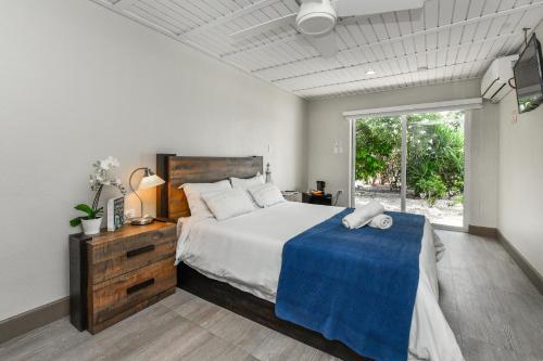 a bedroom with a large bed and a large window at Aloe B&B in Oranjestad