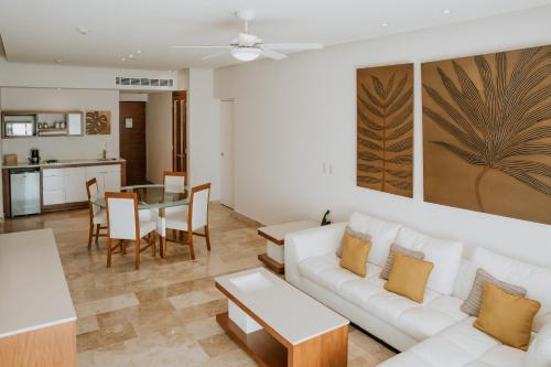 a living room with a white couch and a table at The Reef 28 Hotel & Spa - Luxury Adults Only - All Suites - With Optional All Inclusive in Playa del Carmen