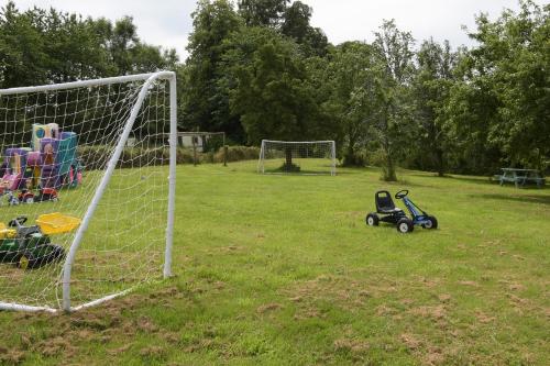 a toy stroller sitting next to a soccer goal at Cae Berllan Cottages in Groeslon