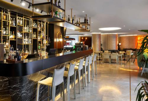 a bar with a bunch of chairs in a restaurant at Radisson Blu Hotel Istanbul Ottomare in Istanbul