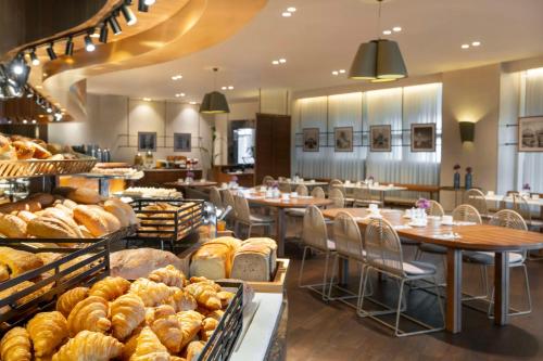 a bakery with a lot of bread and tables and chairs at Radisson Blu Hotel Istanbul Ottomare in Istanbul
