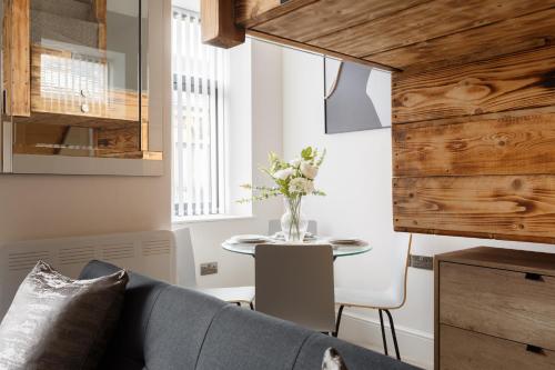a living room with a couch and a table at Bradford Luxury Central Apartment in Bradford