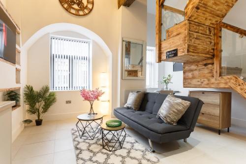 a living room with a couch and a table at Bradford Luxury Central Apartment in Bradford