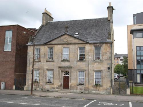 an old stone building on the corner of a street at Number 52 Charlotte Street in Glasgow