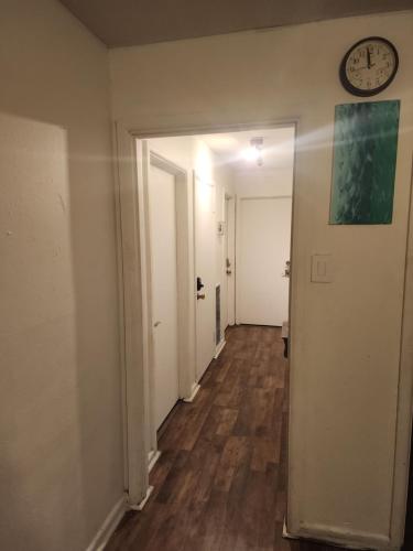 an empty hallway with a clock on the wall at Cozy Private Room 2 with Extras in Dallas