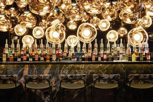 a bar with a bunch of bottles of wine at The Cloud One Gdansk in Gdańsk