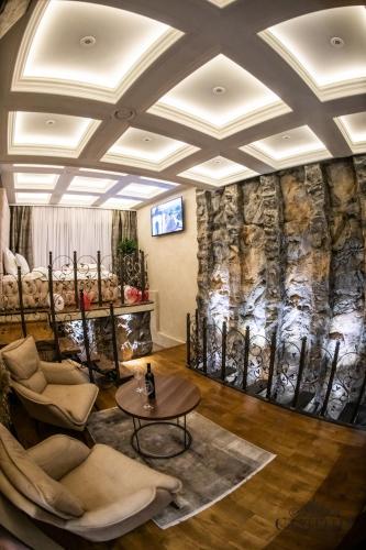 a living room with a couch and a table at Castello luxury spa in Novi Sad