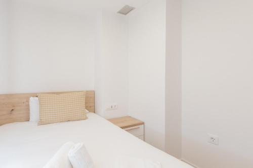 a bedroom with a bed with a pillow on it at Pio XII Apartments Valencia in Valencia