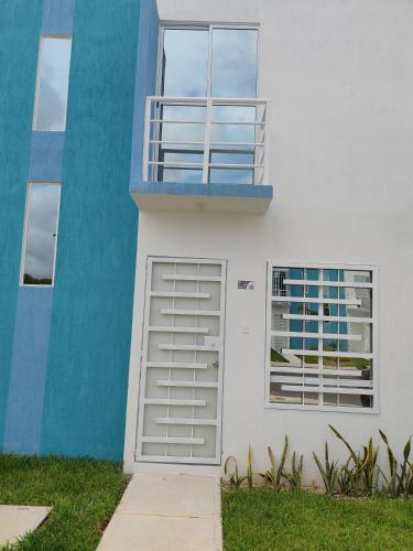 a white and blue building with a door at Privada Monte Aneto 13 in Cancún