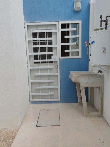 a bathroom with a white door and a sink at Privada Monte Aneto 13 in Cancún
