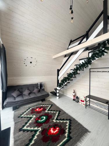 a living room with a couch and a christmas rug at Шале WeLKoMe in Verkhovyna