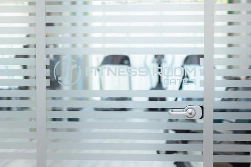 a person looking through the blinds of a window at JR Hotels Gate 7 Bologna in Calderara di Reno