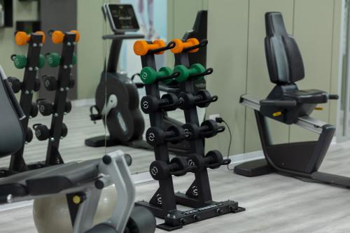 a row of exercise equipment in a gym at JR Hotels Gate 7 Bologna in Calderara di Reno