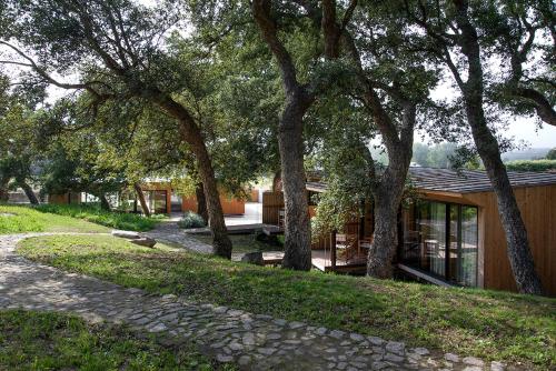 a house with trees and a path in front of it at Wood Mood Lodges in Caminha