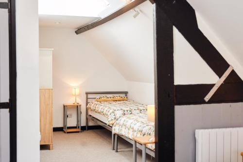 a bedroom with a bed in a attic at Farm stay close to Shakespeare's Stratford-upon-Avon in Stratford-upon-Avon