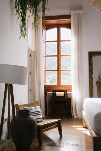 a living room with a large window and a couch at Dreamsea Boutique Experience in Moya