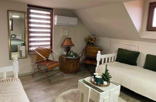 a living room with a bed and a table at Kuća Čerevićki Vidikovac in Čerević