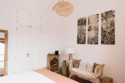 a bedroom with a bed and a chair at Dreamsea Boutique Experience in Moya