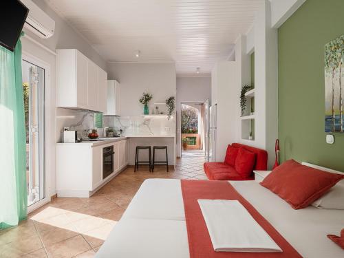 a kitchen and a living room with a bed in a room at Elena Seafront Luxury Apartments in Almirida