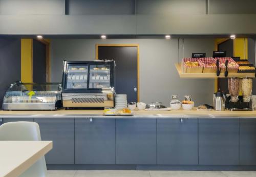 a kitchen with a counter with aasteryasteryasteryasteryasteryasteryasteryasteryastery at B&B HOTEL Longwy Porte du Luxembourg in Longwy